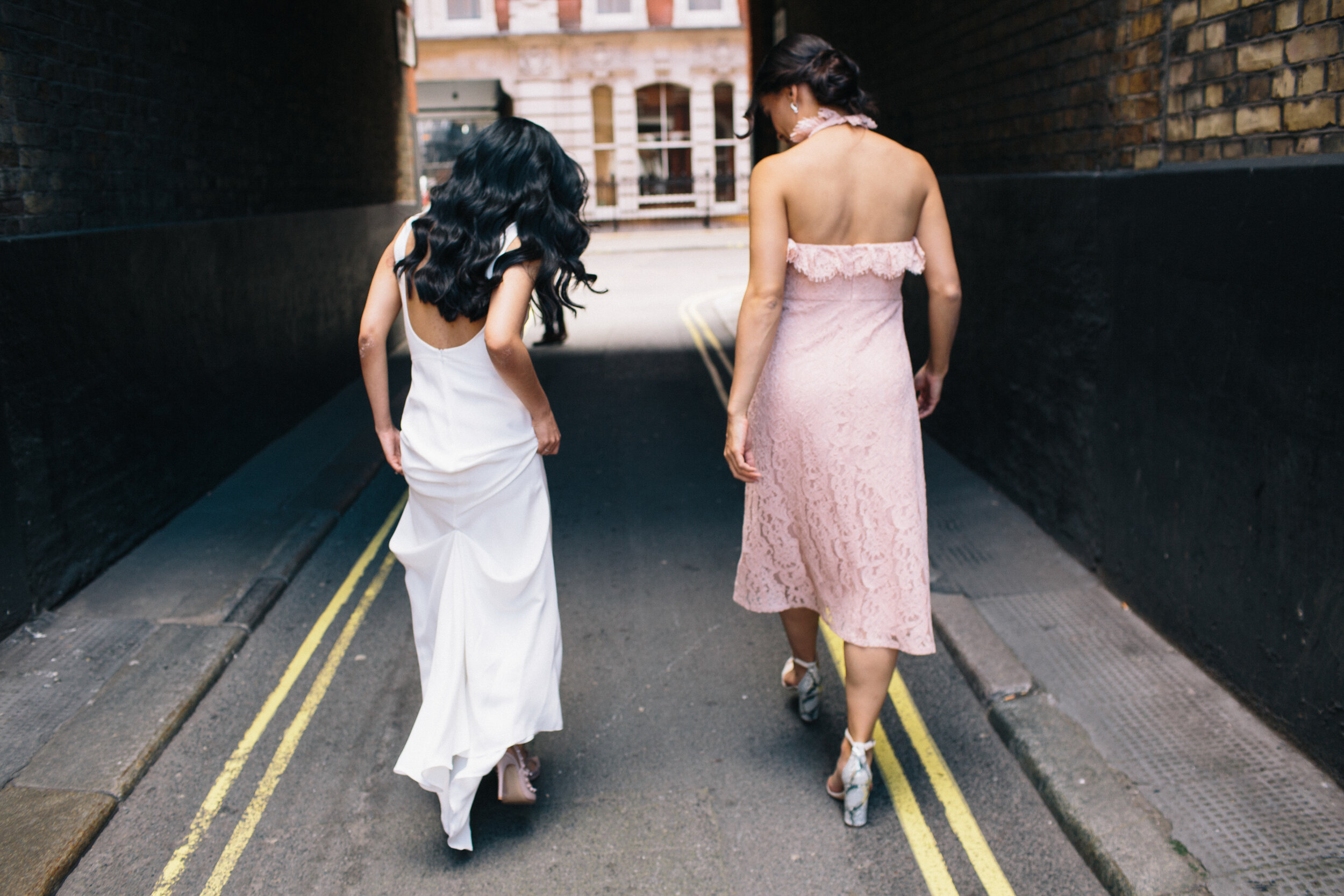 Bride in Wedding dress walking through Soho alleyway