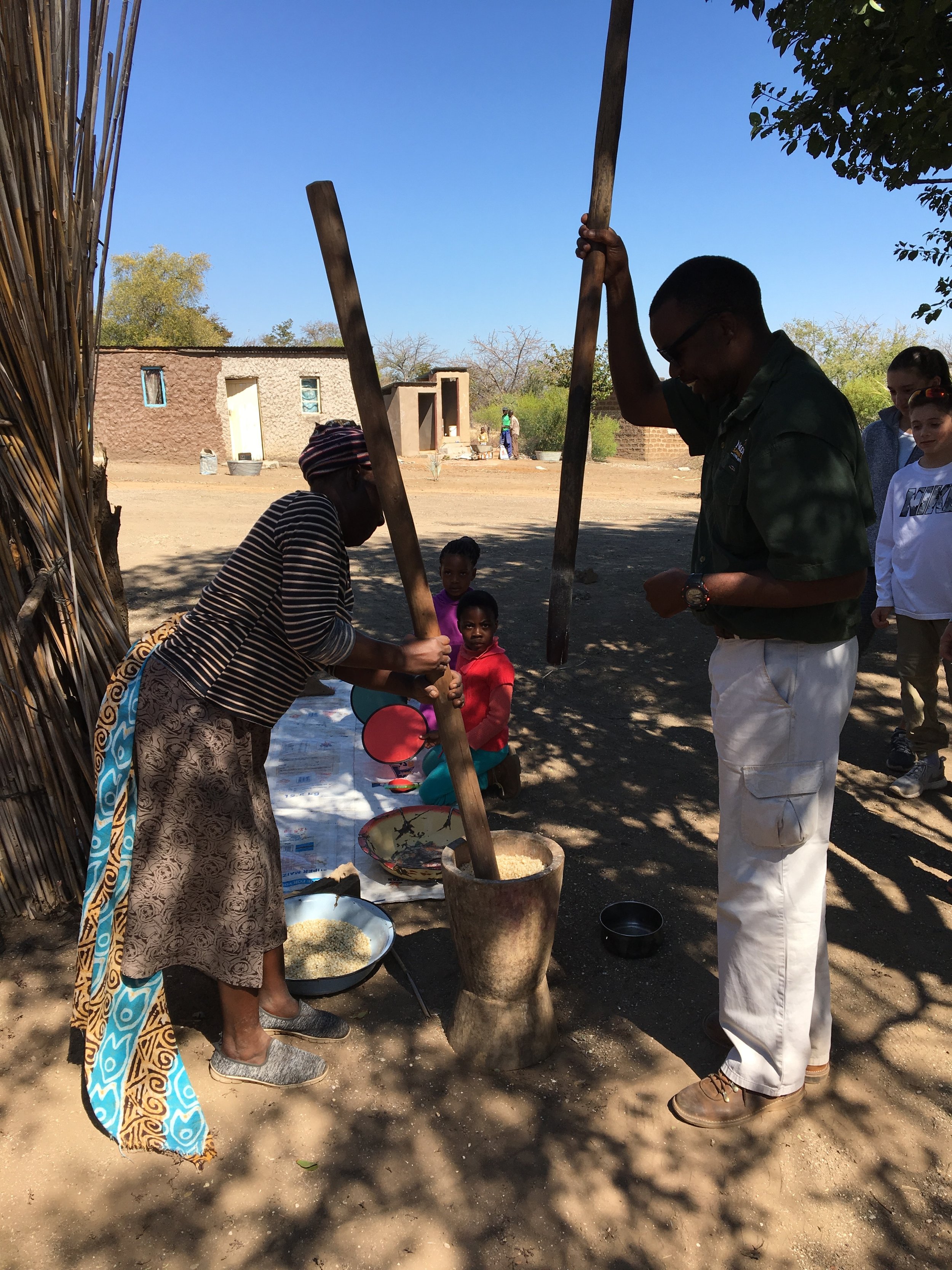 Grinding corn in Mabele, Botswana