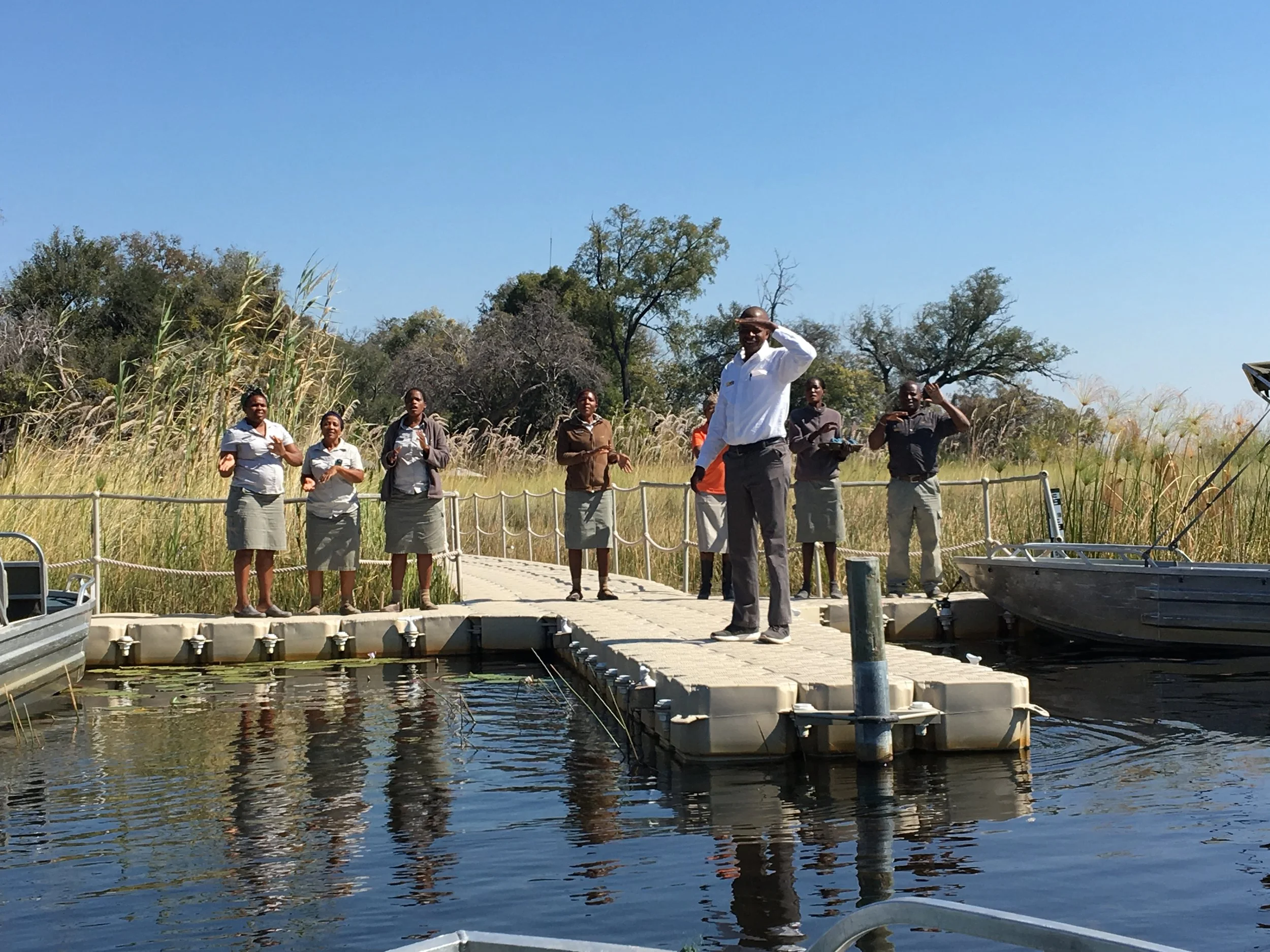 The Little Vuumbura staff welcomes us as we pull into the dock, Botswana
