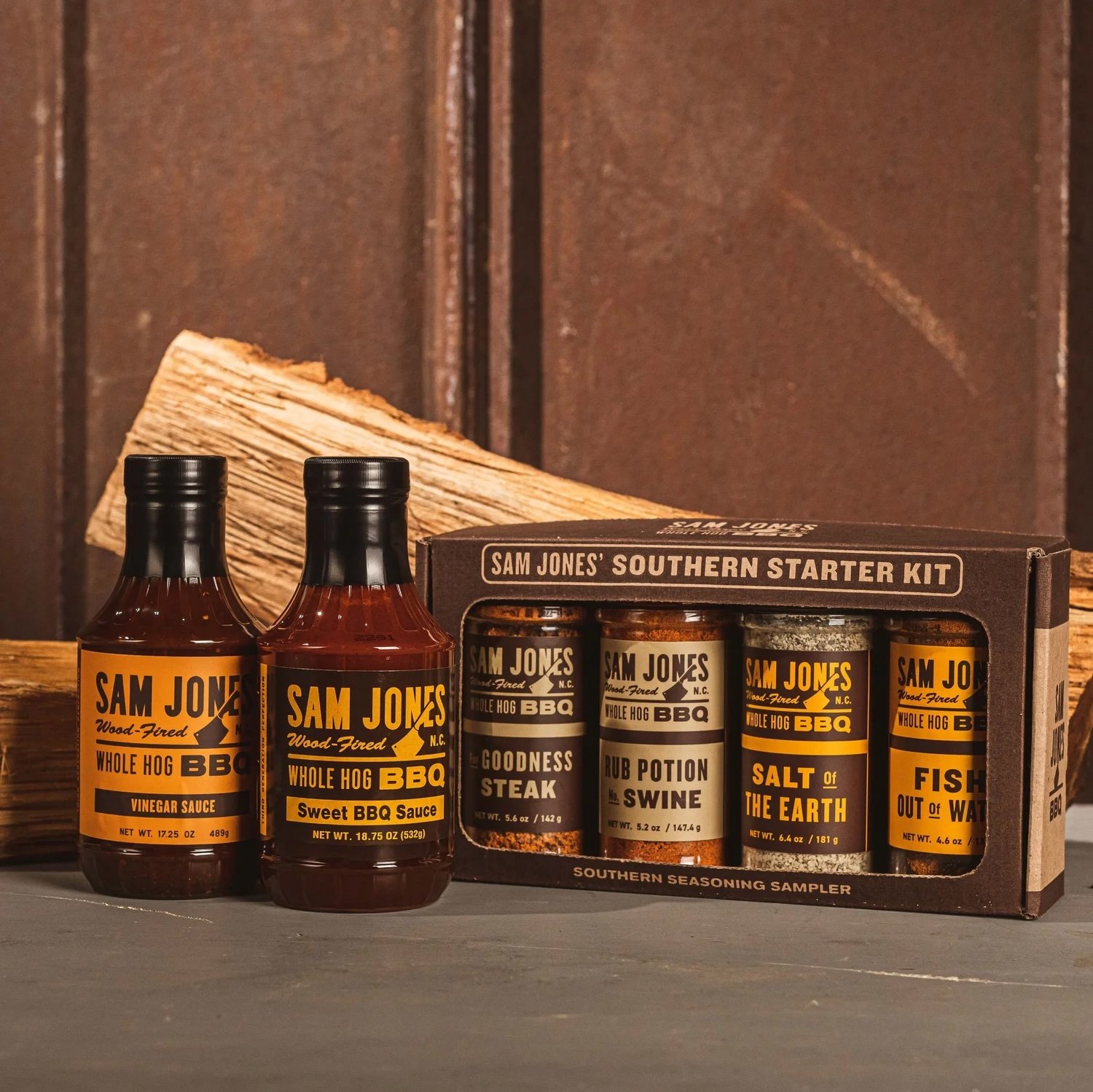 Pictured: Sam Jones BBQ Sauces & Spices Gift Set. From left to right: Vinegar Sauce, Sweet BBQ Sauce, For Goodness Steak Rub, Rub Potion No. Swine, Salt of the Earth Rub, & Fish Out of Water Rub.