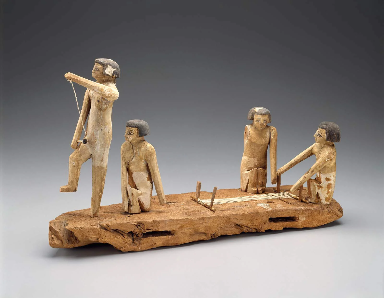 Egyptian, Middle Kingdom, late Dynasty 11 – early Dynasty, 2010–1961 B.C. Painted wooden model of a group of women spinning and weaving. The two women at the front are spinning flax. The two women at the back are working on a loom. Museum of Fine Arts, Boston.