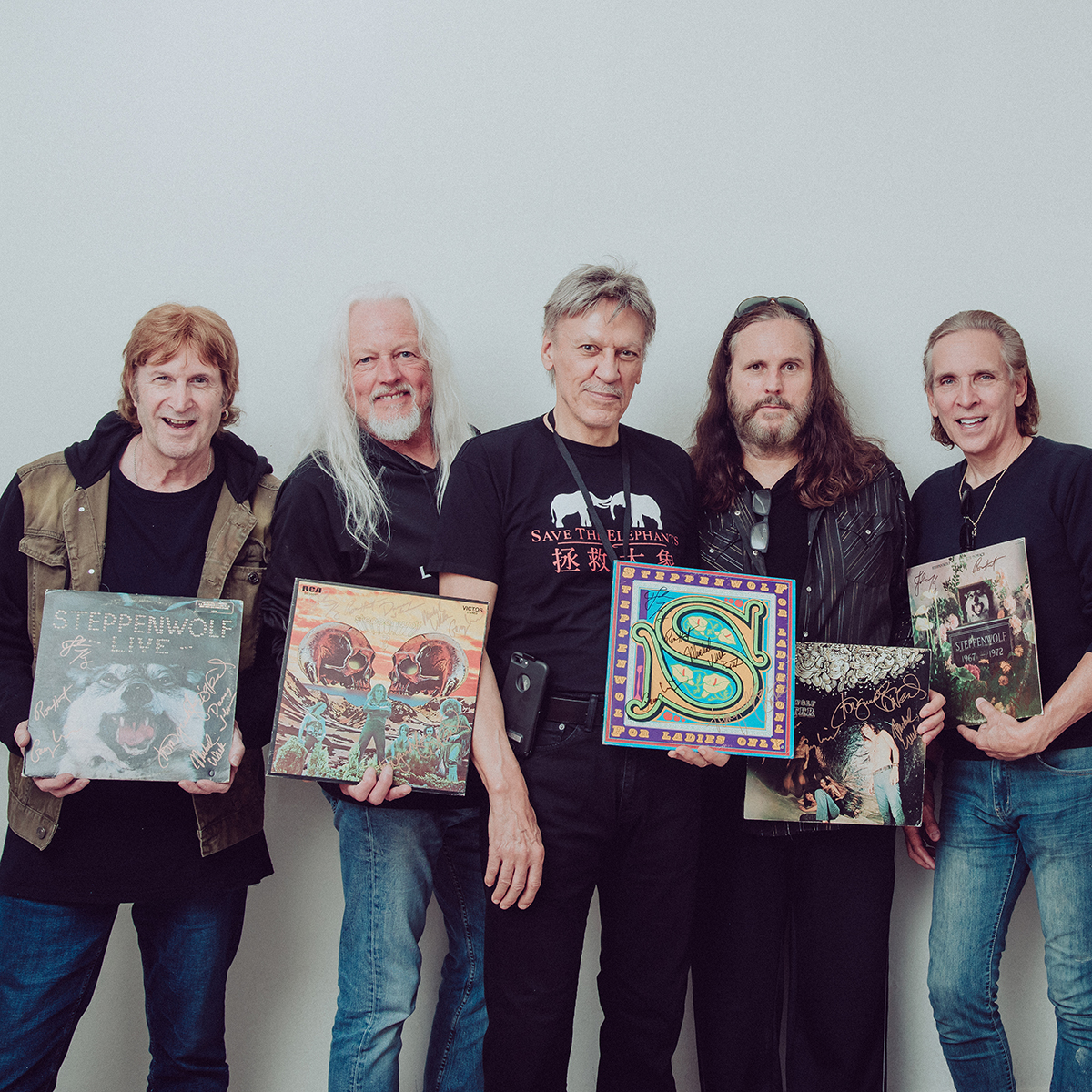 john kay and steppenwof final band photo posing with records.jpg