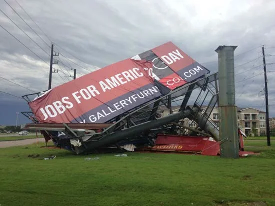 billboard in Katy, Texas, toppled over by less than hurricane force winds