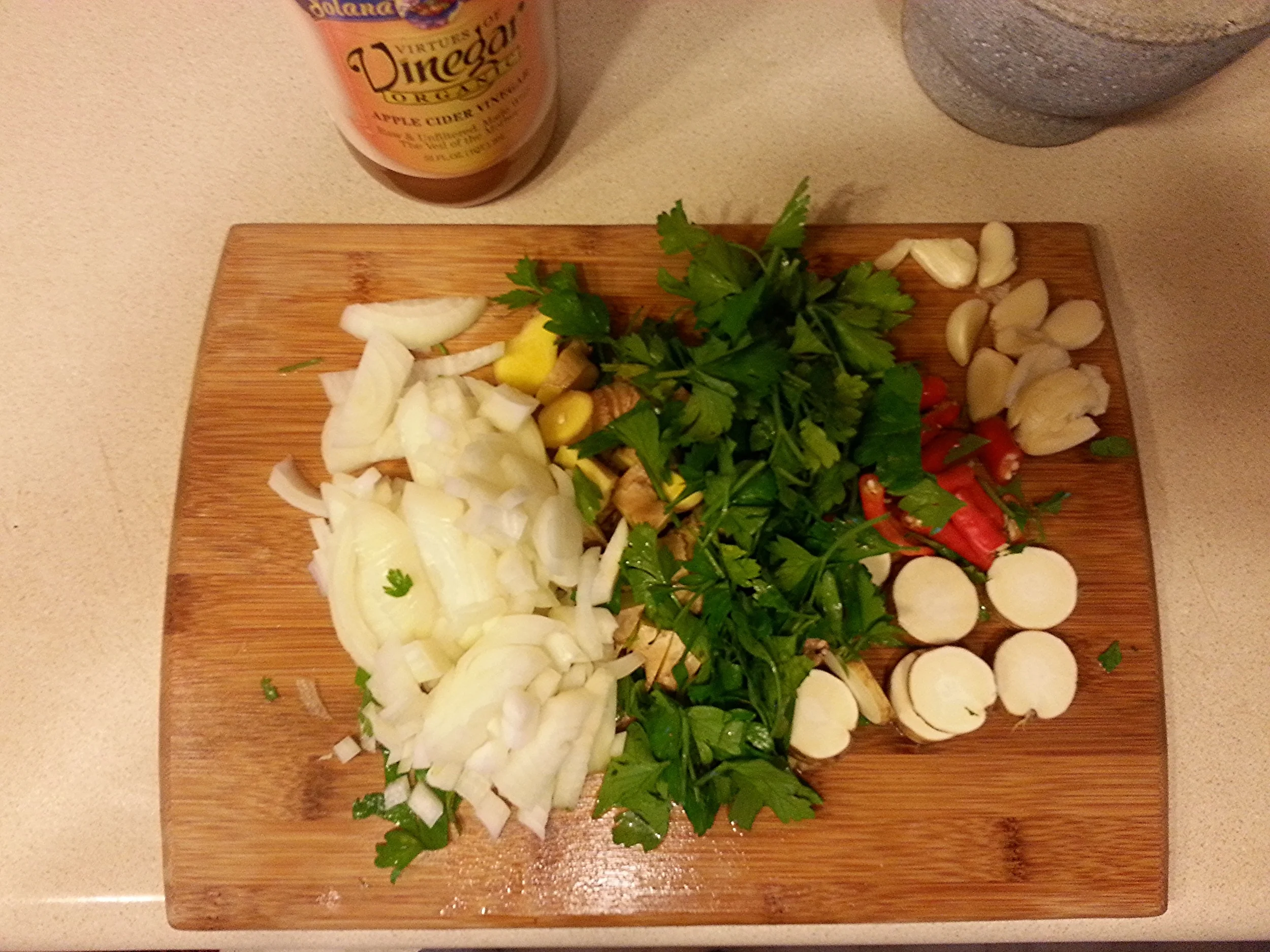 2. Chop up your ingredients a bit so they blend up easily; peel your garlic and take the green heads off your cayenne peppers. 