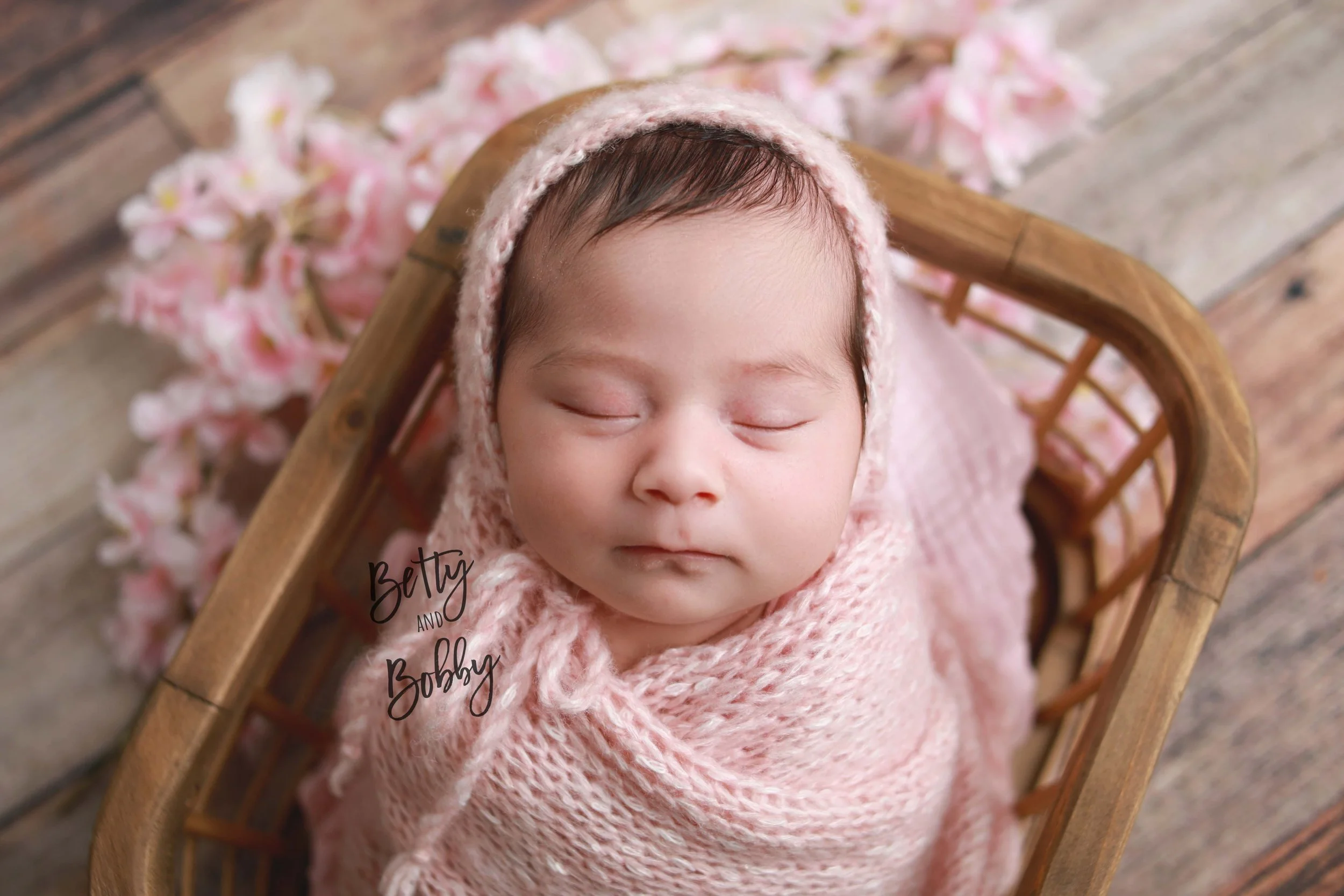 Posed newborn photography. Wrapped newborn in basket in Muncie Indiana studio