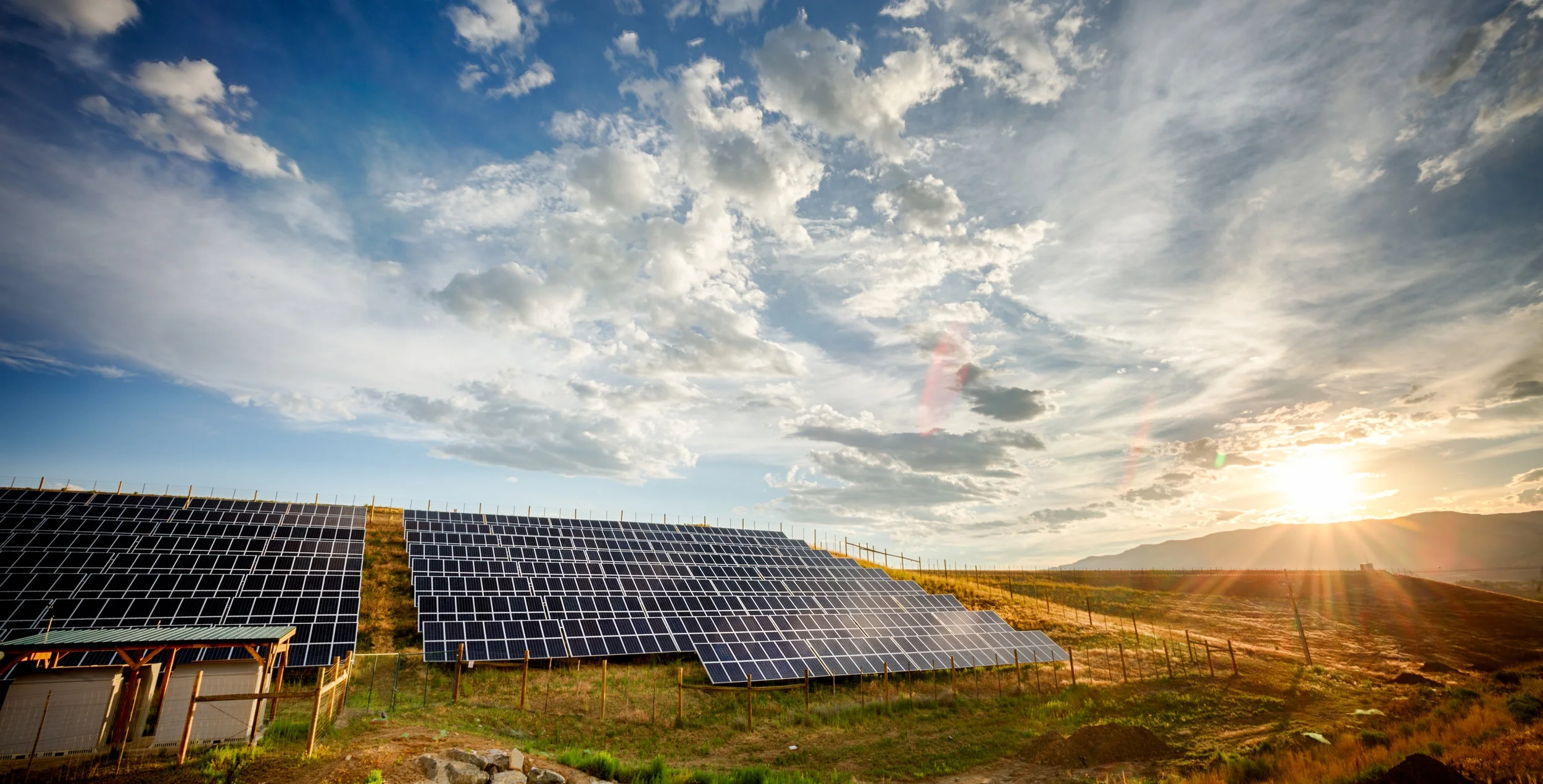 Solar-Panels-and-Green-Field-Under-Dramatic-Sky-at-Sunset-474147572_3871x2576.jpeg