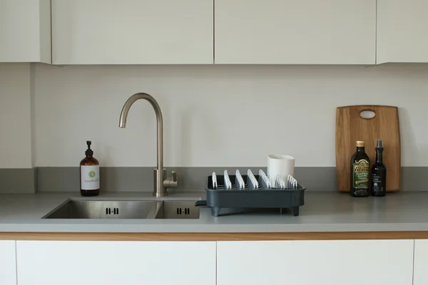 The sink area of a standforth bespoke kitchen, Corian work surface, stainless steel sink and tap