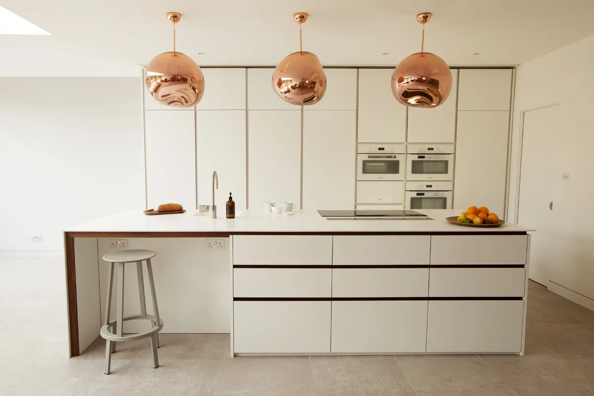 High specification bespoke kitchen by standforth with pocket doors to wall cabinets closed