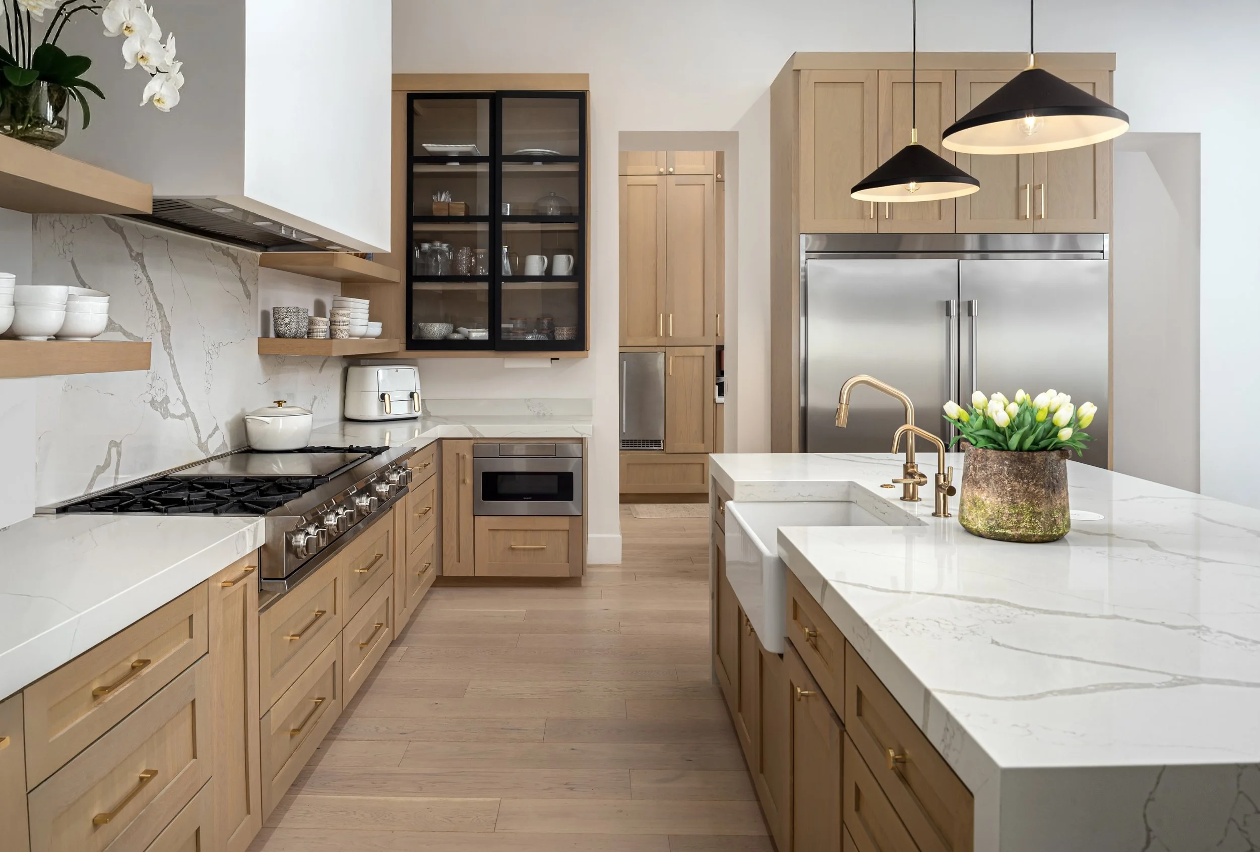 Architecture and design photography in arizona of a custom kitchen with gold accents,  stainless appliances, and shaker-style cabinets