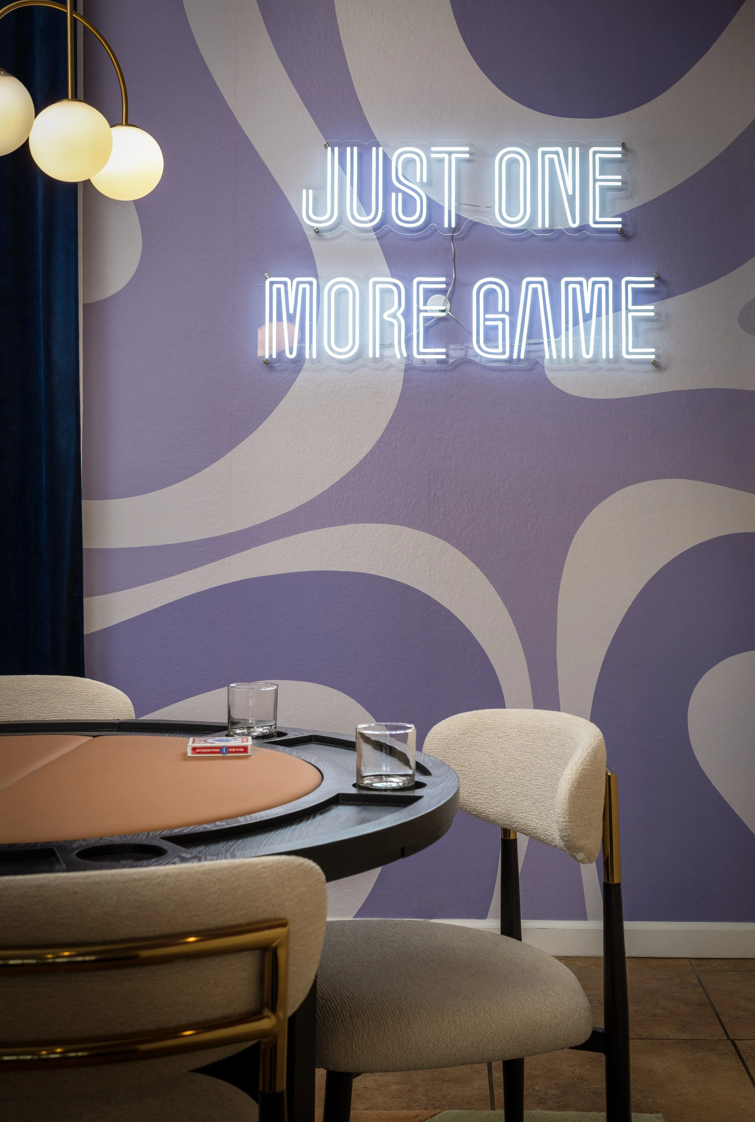 Game room photographed by sean colon Photography with a poker table, drinkware, and neon sign saying "JUST ONE MORE GAME" at a scottsdale arizona airbnb