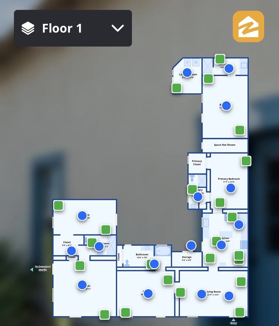 Floor plan of a house with multiple rooms, including a living room, kitchen, primary bedroom, bathrooms, closets, and an office/studio with various icons indicating features or furniture.