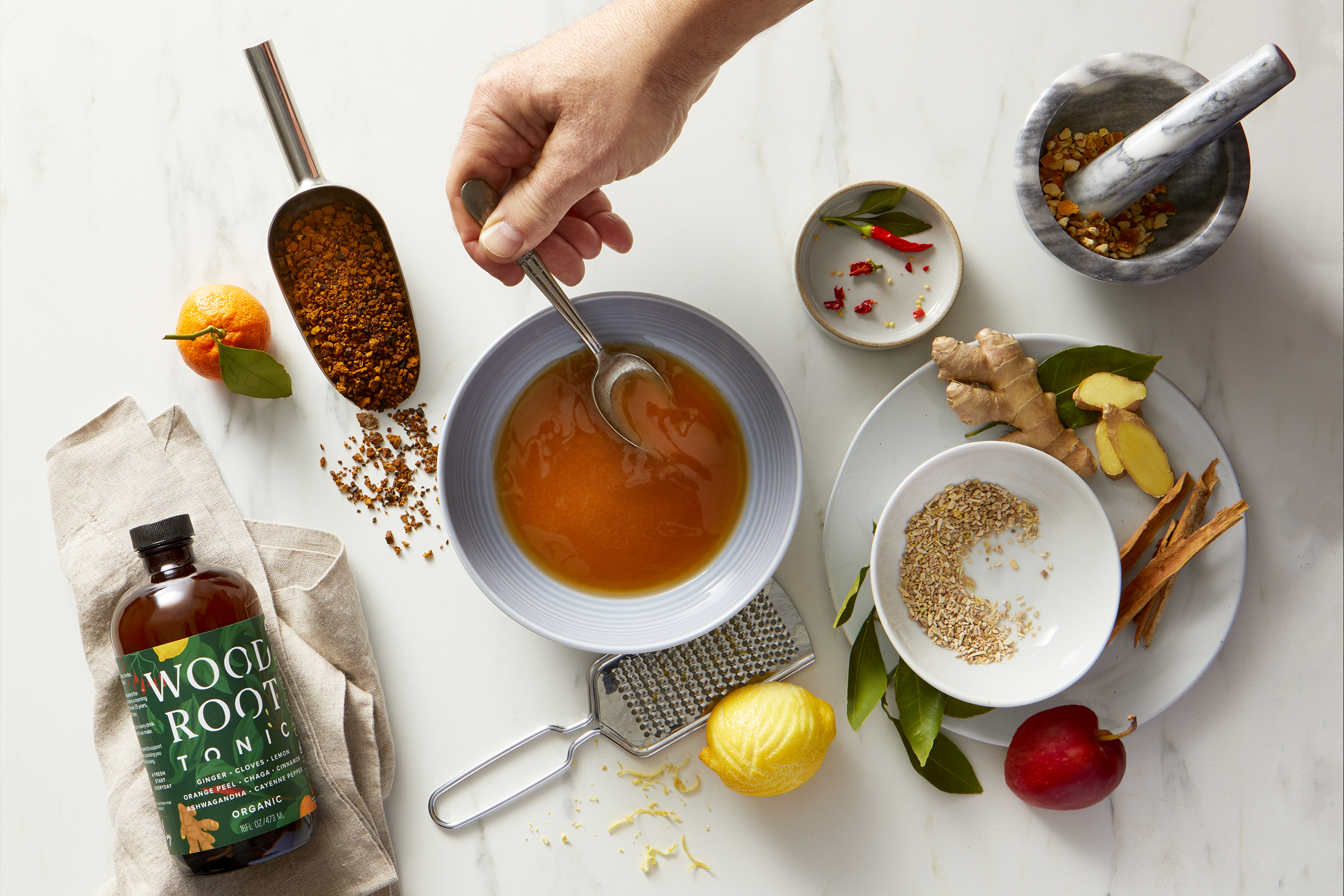 Woodroot_Tonic_HandAction_Bowl_Web.png