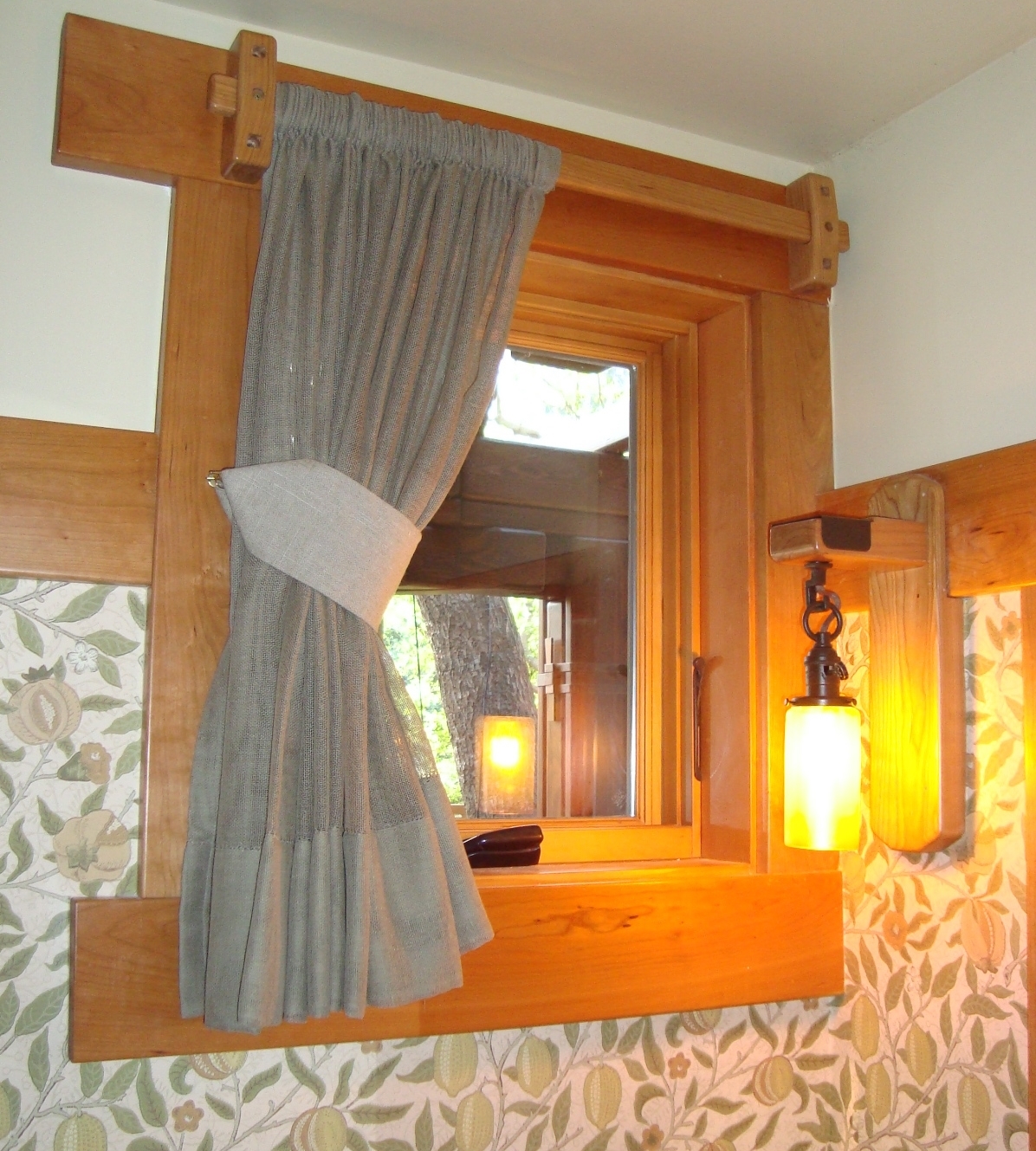 A hold back can lift a curtain away from the widow to let in more light.
