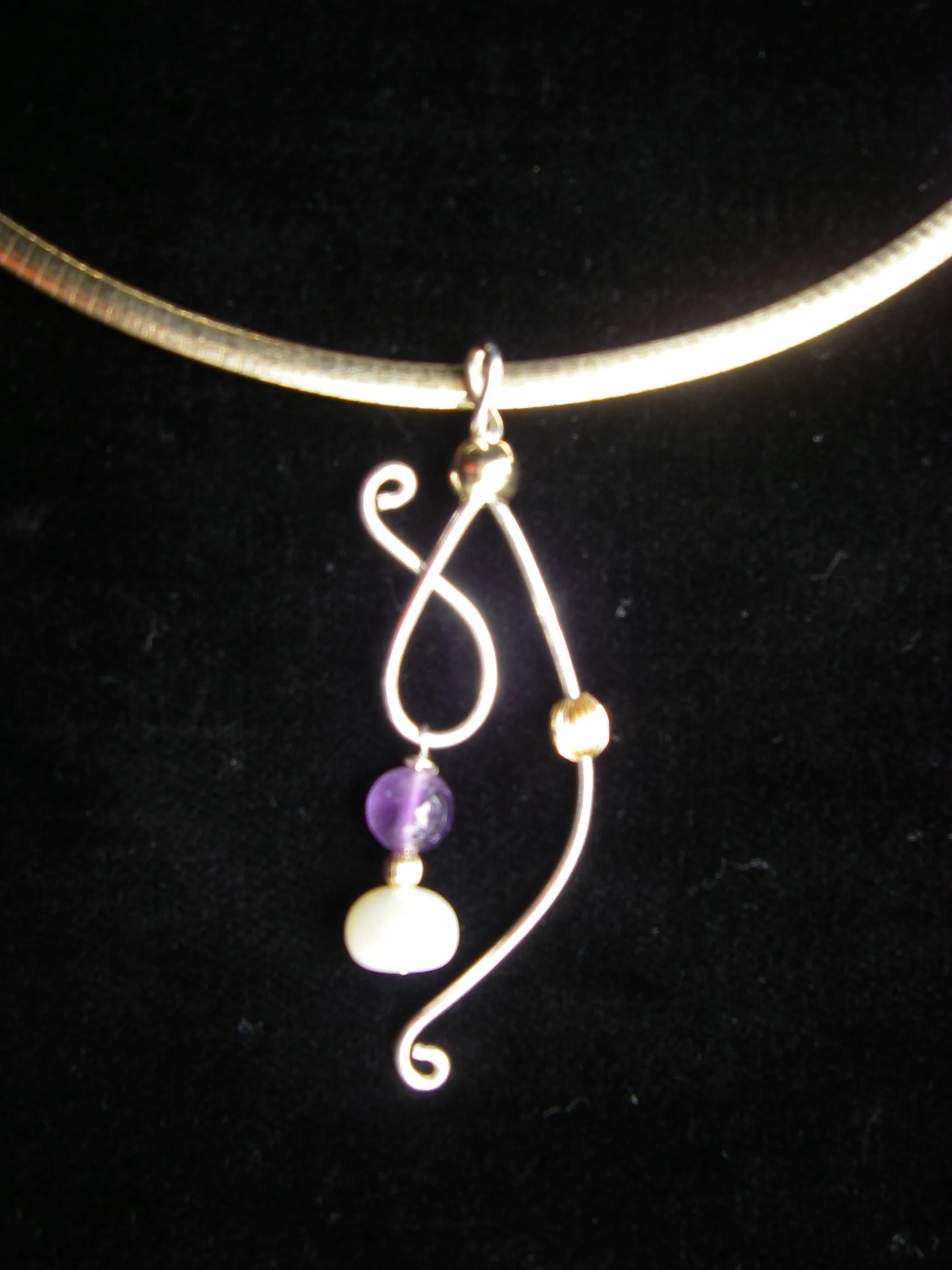  "Spirit of Women" pendant given to the participants at the event  837 individual pendants were made by hand with unique combinations of amethyst stones and pearls for each   