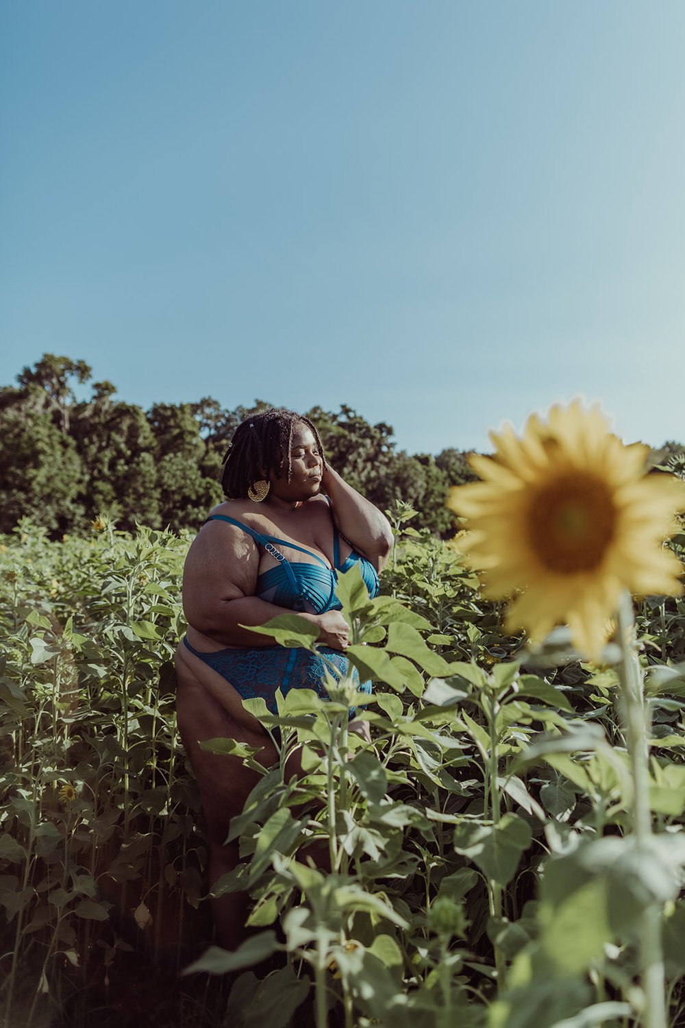  beautiful black woman basks in the sunshine in blue lingerie from Torrid during her photoshoot 
