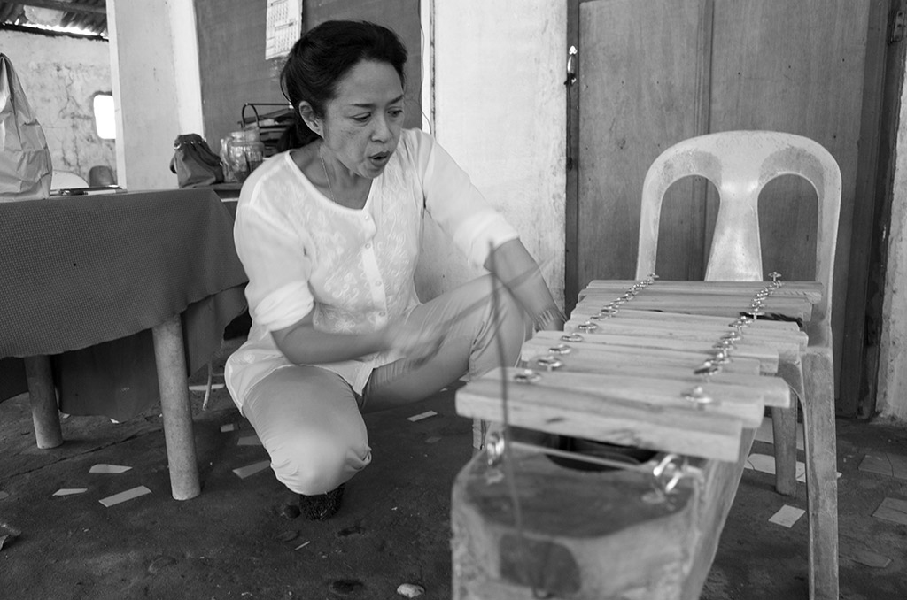 President Jalandoni praising a xylophone crafted by out-of-school youth