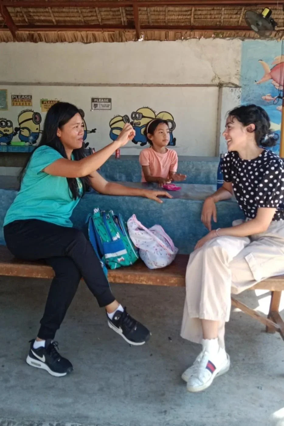 Volunteer speech pathologist signing with one of the parents.
