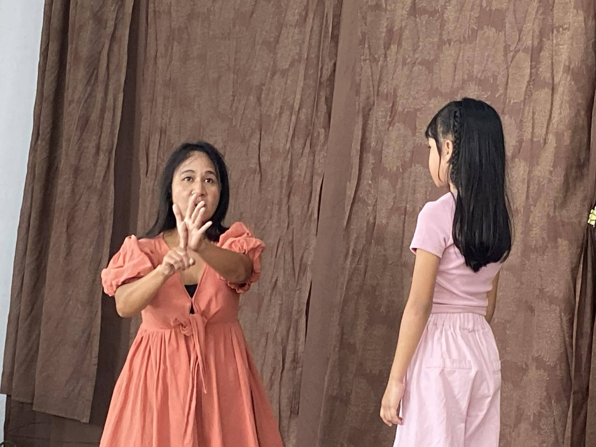 Welcome Home Foundation student and mother interpreting a song