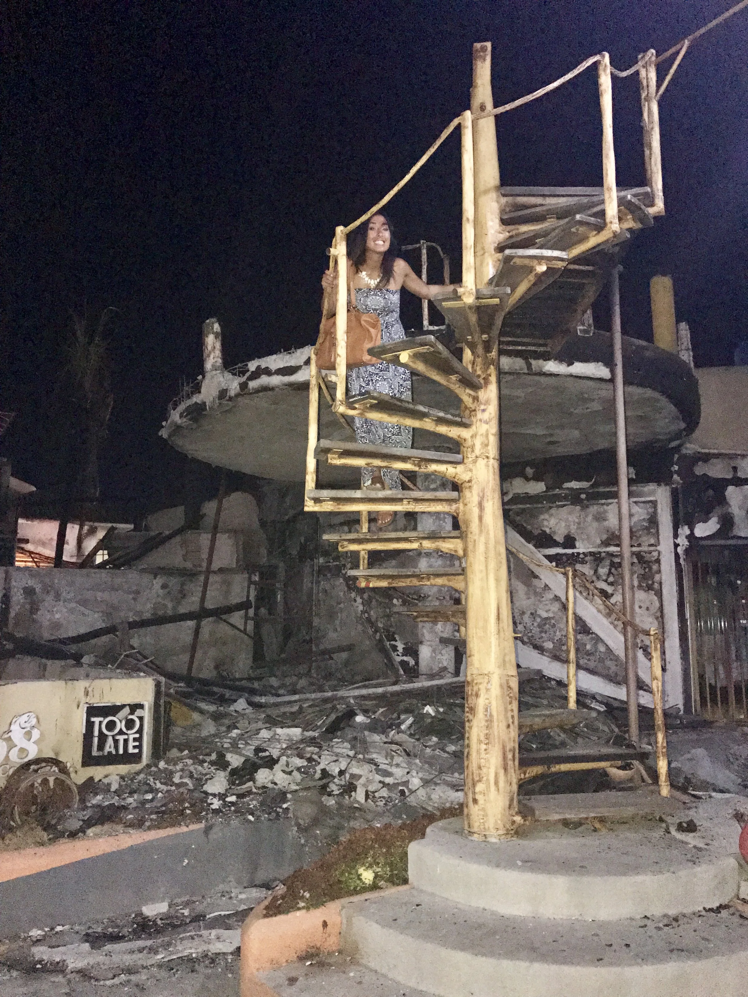 I appreciate the "Too late" sign on the crumbling facade of the building and the still remaining spiral staircase. 
