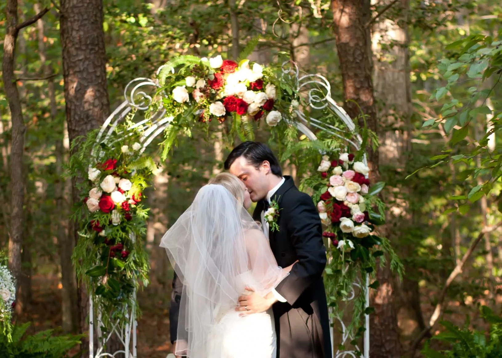 wedding ceremony first kiss bride groom ceremony alter florals .jpg