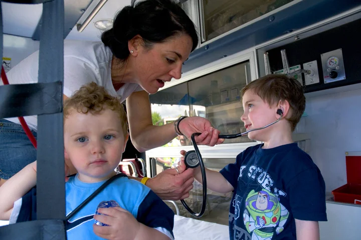 Children learning about the activities that takes place inside an ambulance at "Touch a Truck" in Danvers, MA.