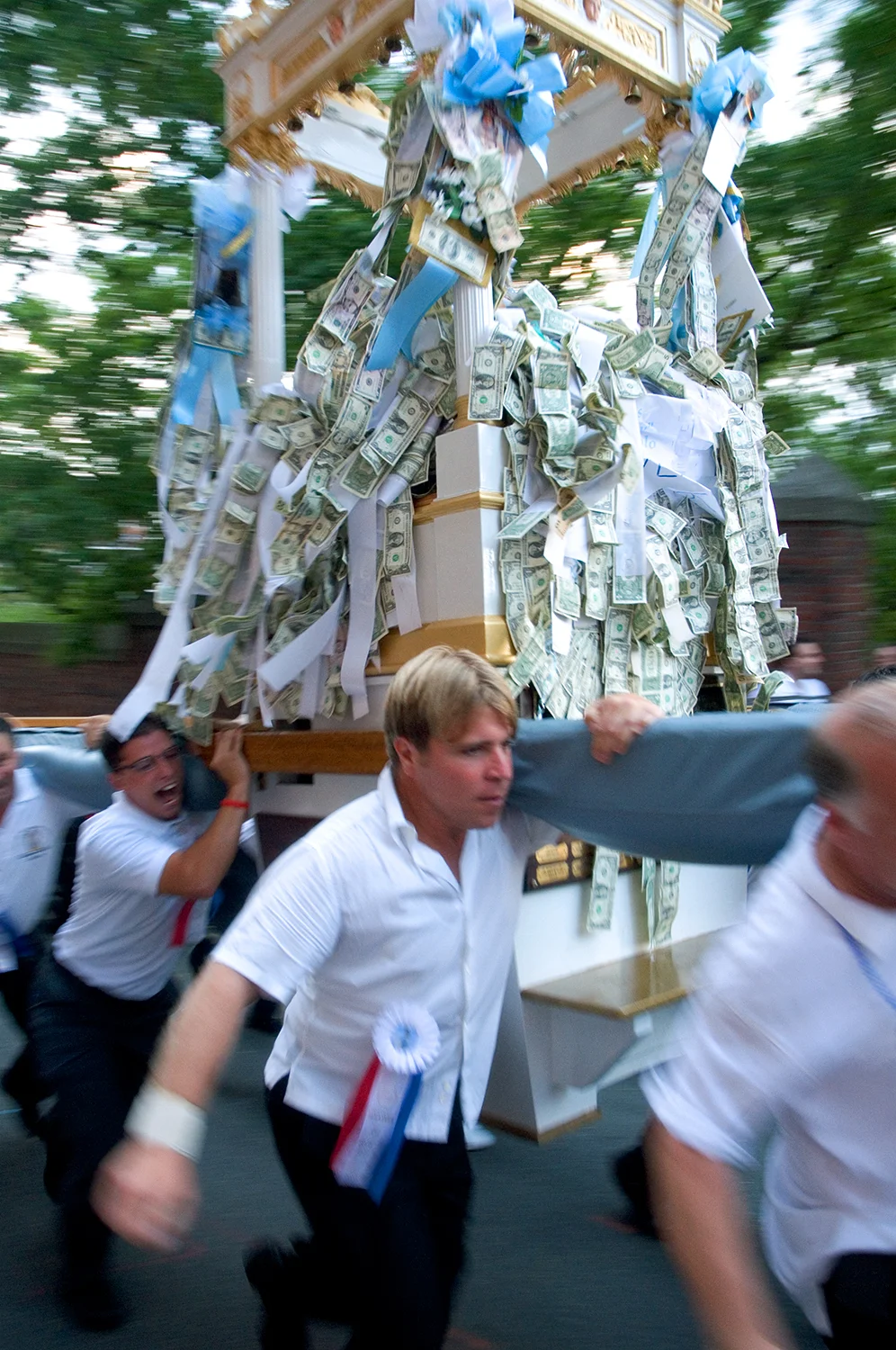 Man of the Fisherman's Feast run Madonna del Soccorso di Sciacca up a steep hill at Boston's North End.