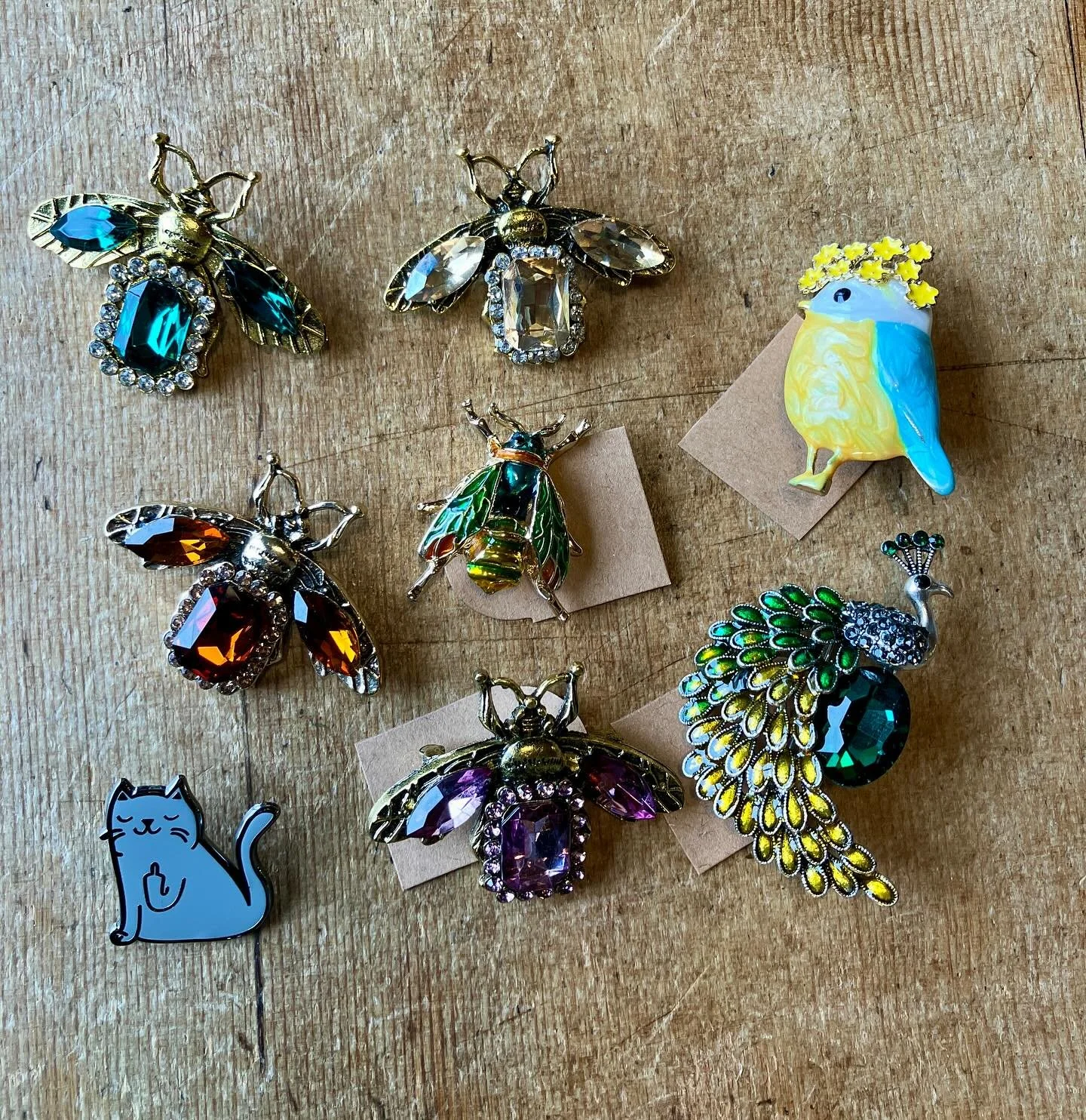 Come and see our collection of pins from irreverent to elegant. Great for a winter jacket lapel, or an addition to a hat. We even have something for the Westsound Peacock supporters! We&rsquo;re open today until 5 PM. And every day 10 AM to 5 PM exce
