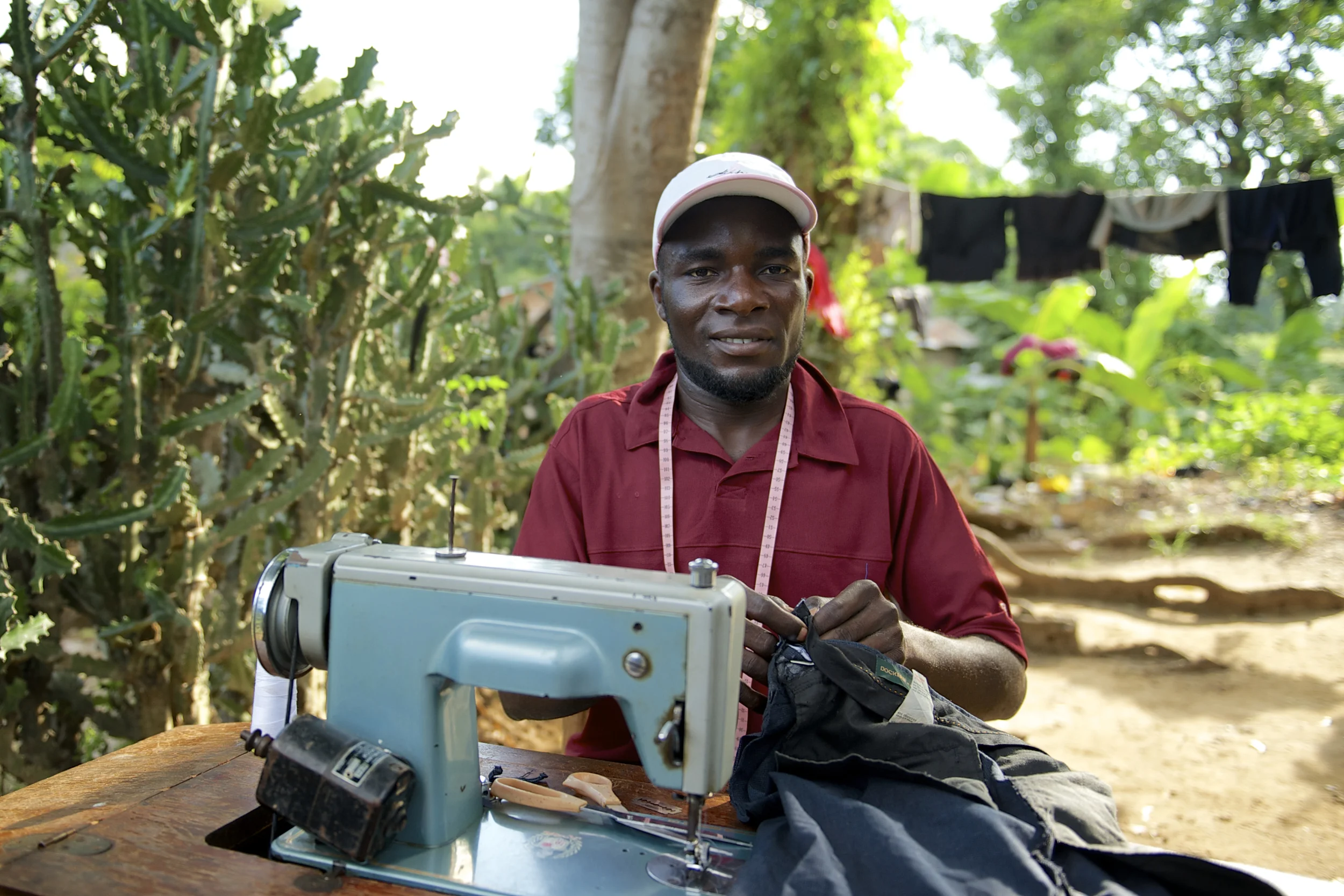 Joseph Phanalime has been a tailor since he was 17 years old. He works with a foot-treadle sewing machine.