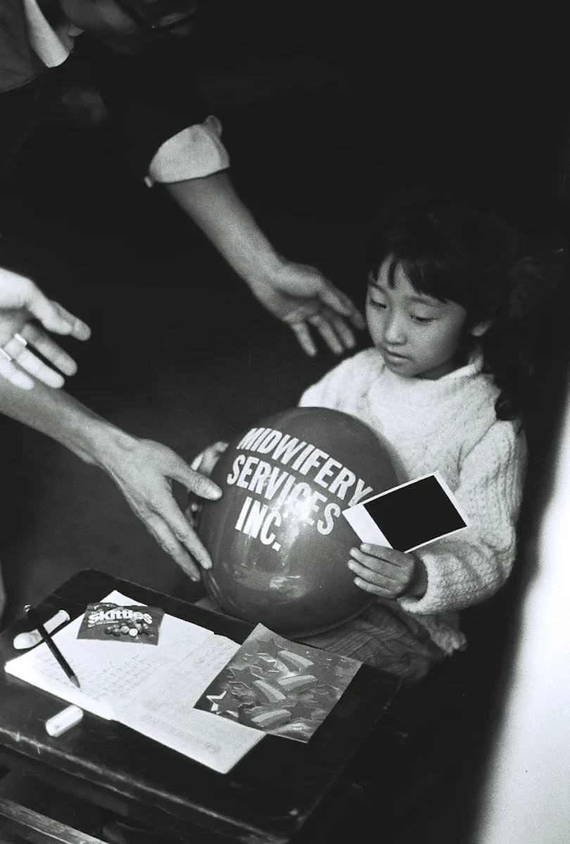 A girl doing her arithmetic homework in a doorway before we interrupted her with adoration and simple gifts.