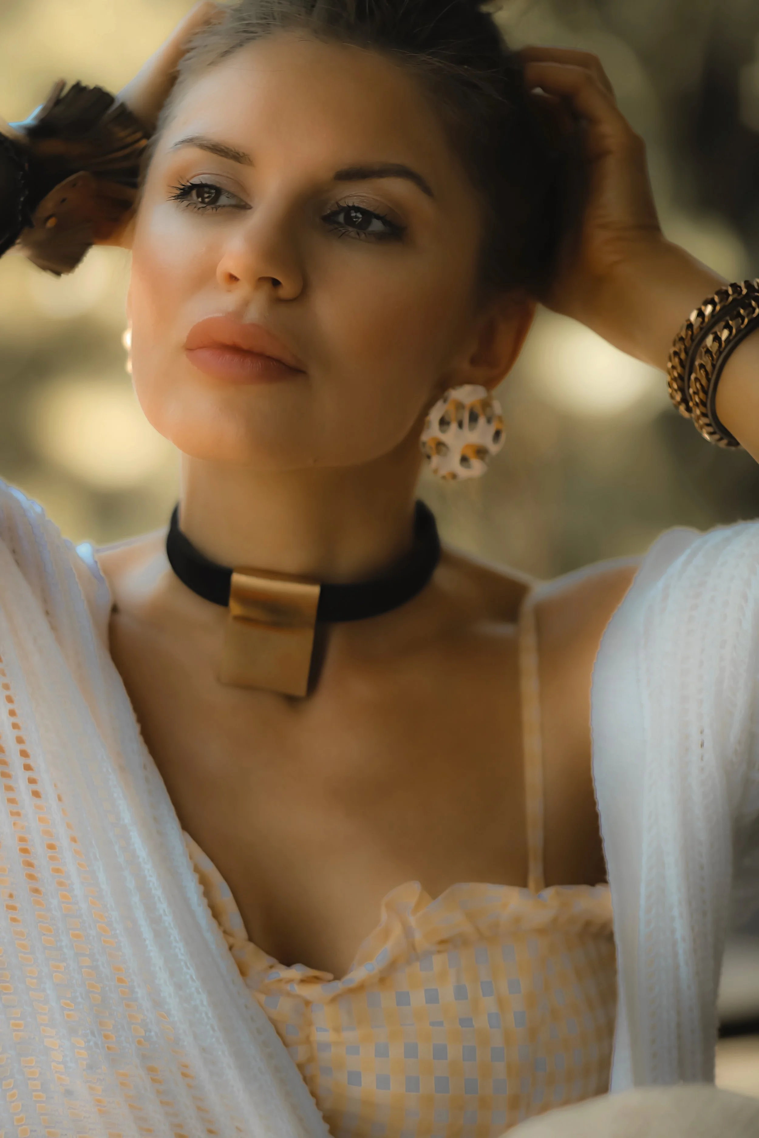 Isabel Alexander wearing a gold leather choker