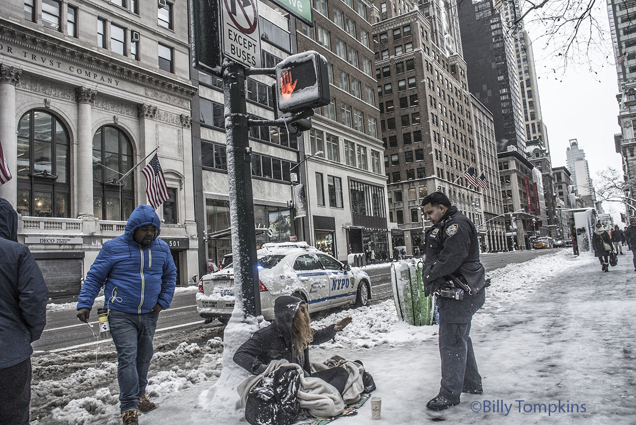 Cop speaking to a homeless person during frigid cold weather