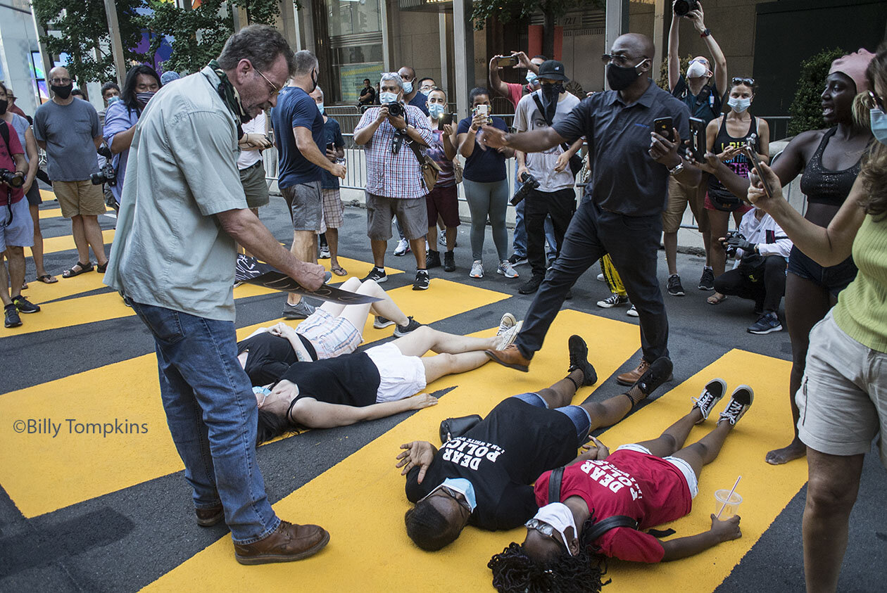  White man standing over young black women telling them that they are lucky to be living in this county, as the father of one of the girls intercedes and tells him to back away from his daughter.   Black Lives Matter Protest  New York City 