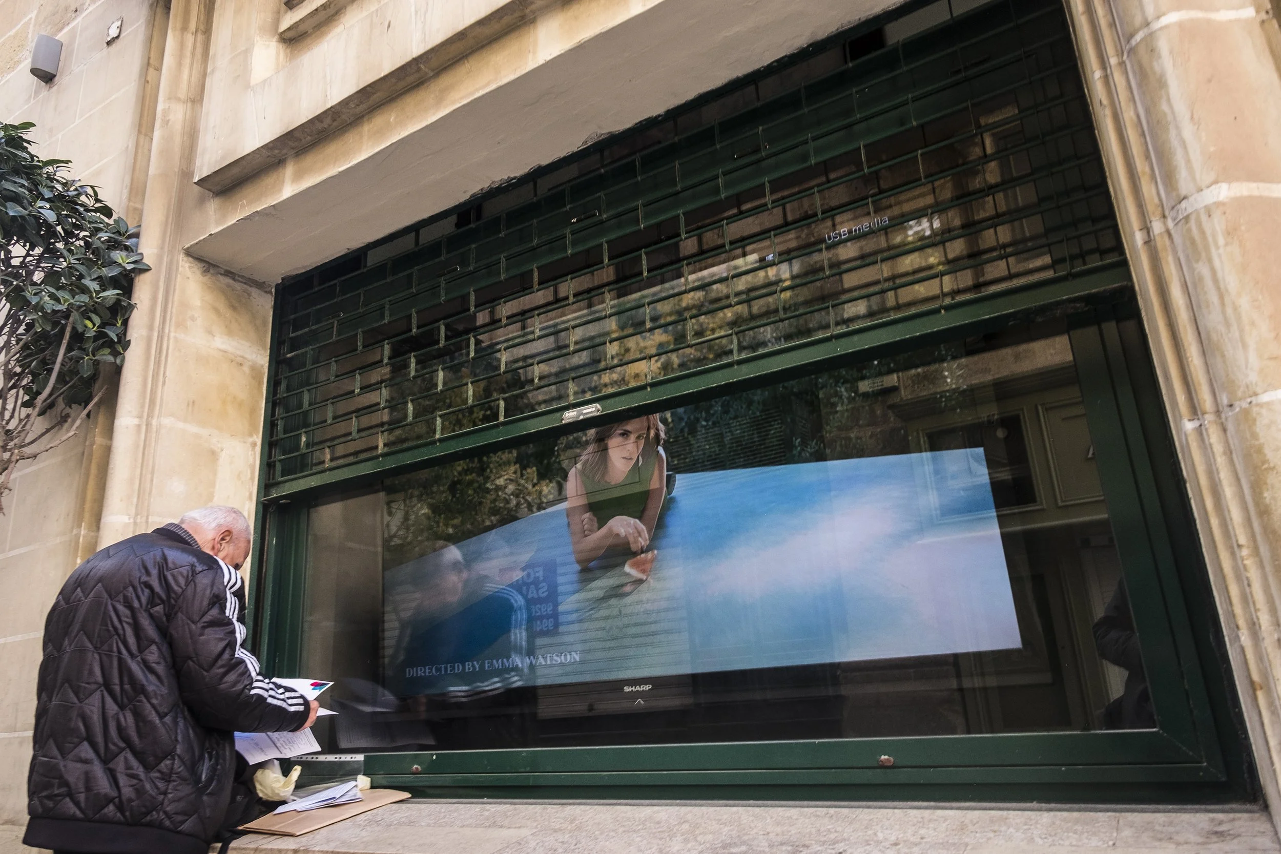 Man in front of Electronics Store