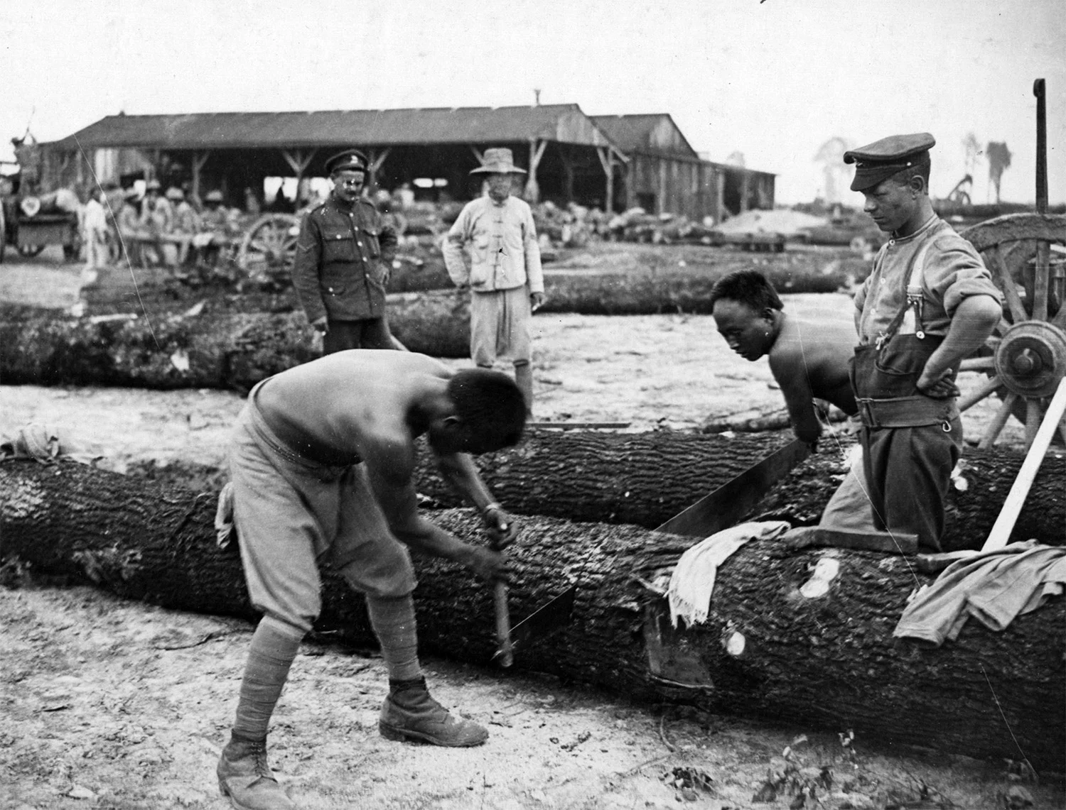 Chinese labourers at work on the Western Front, supervised by white British troops. 