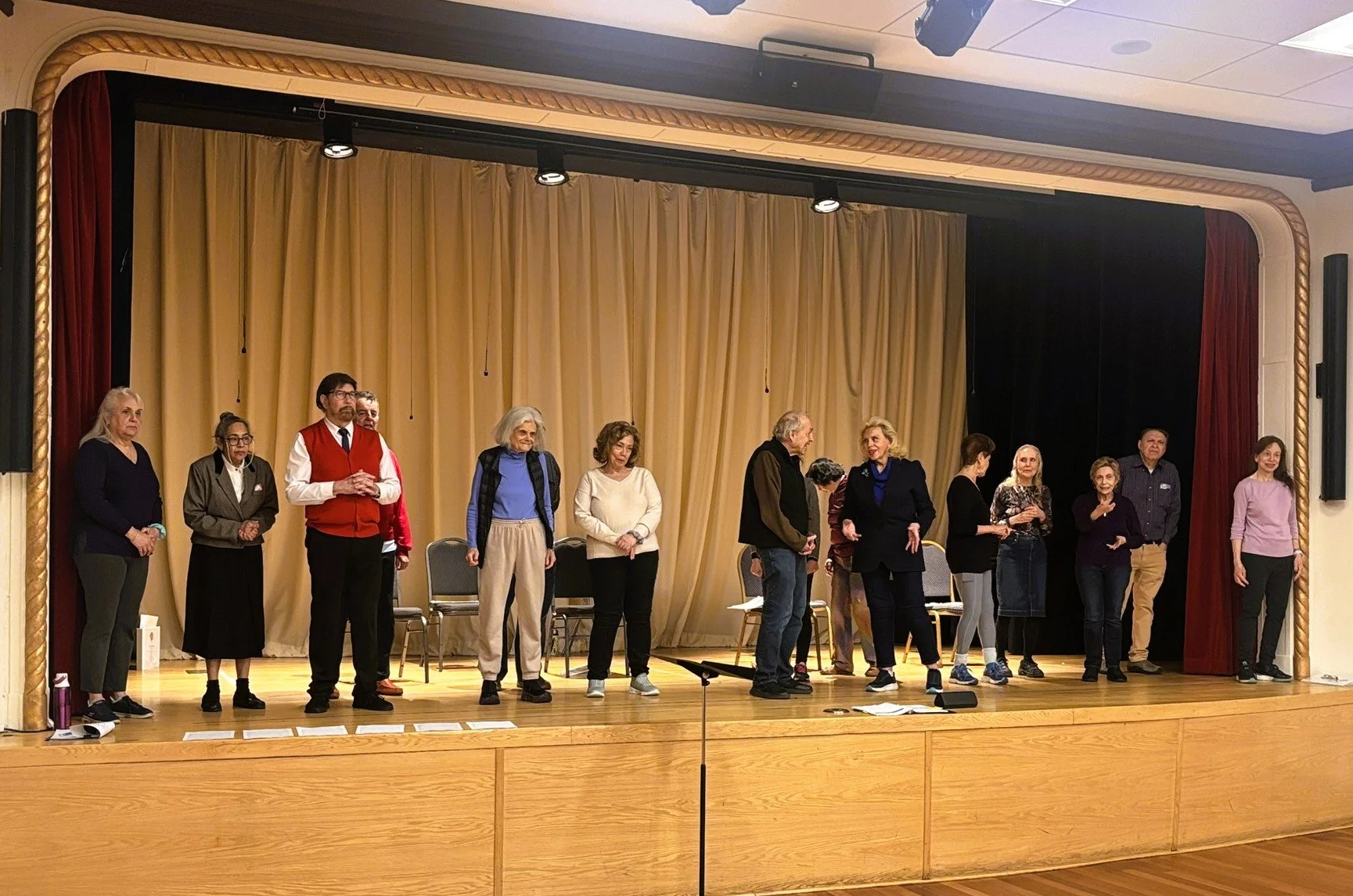 Older adult center cast members rehearsing on stage