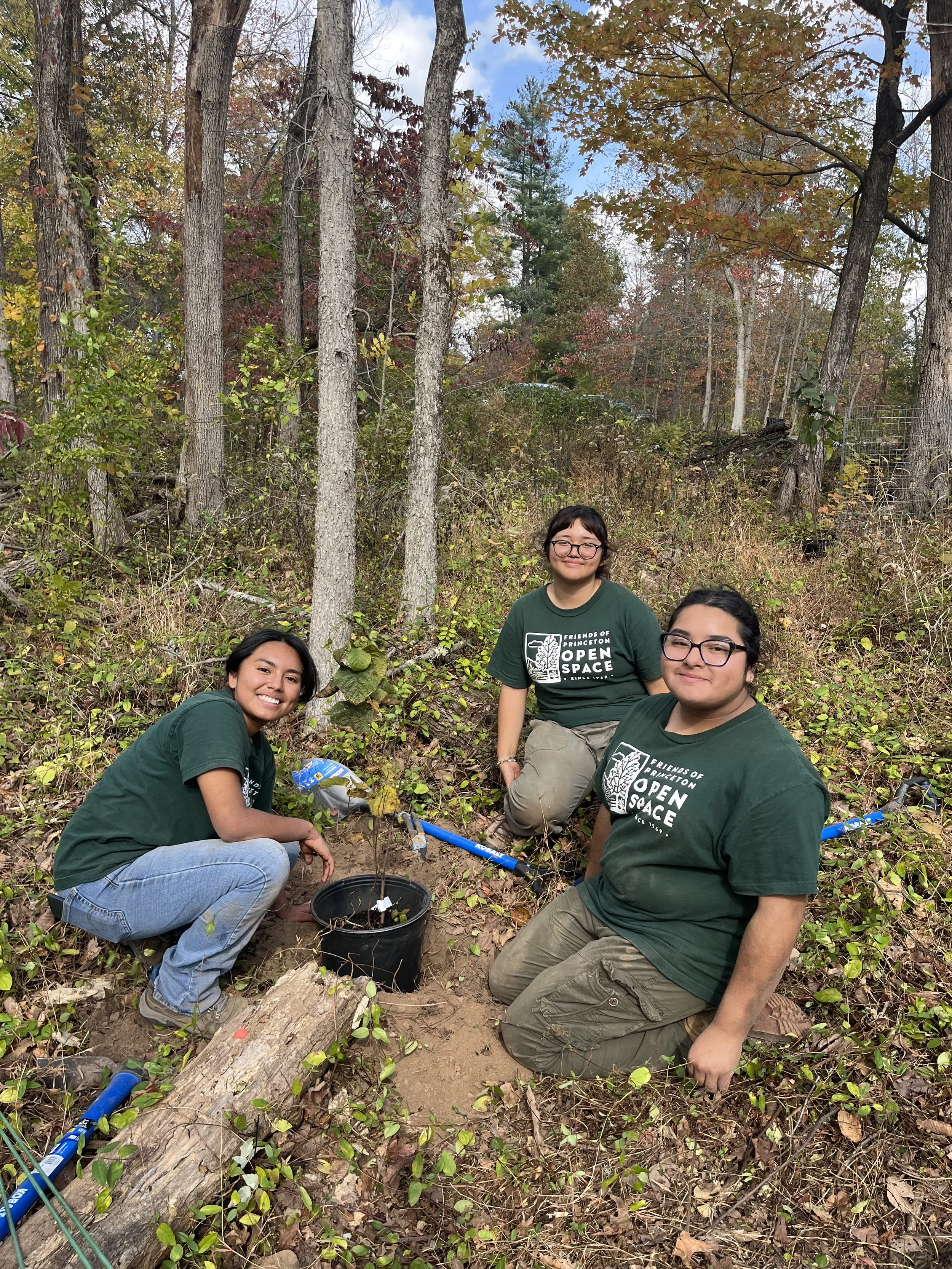  Three of our 2025 interns leading a planting demonstration in the riparian restoration project 