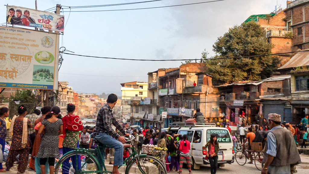 A man sits on top of a local bus with two gas bottles - a rare sight these days in Kathmandu.
