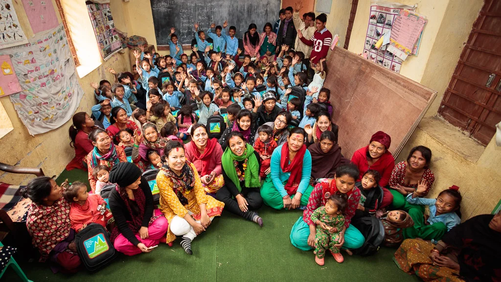 Children, teachers, parents and volunteers from Moving Mountain Nepal and Unatti Group Home for Girls pose for a group photo on donation day - February 1st, 2018