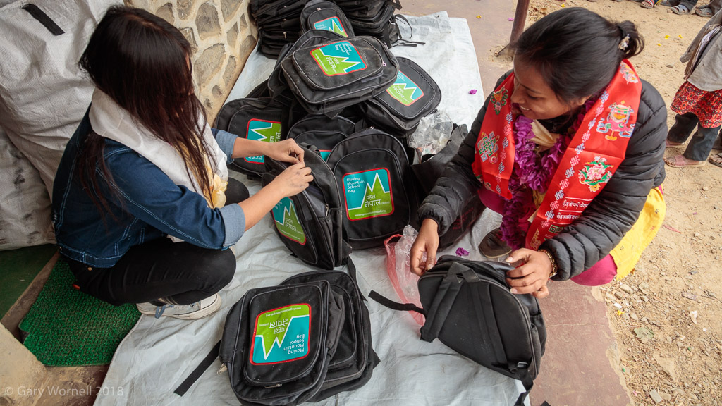 Anita and one of the girls from Unatti unpack the bags in preparation for the ceremony.