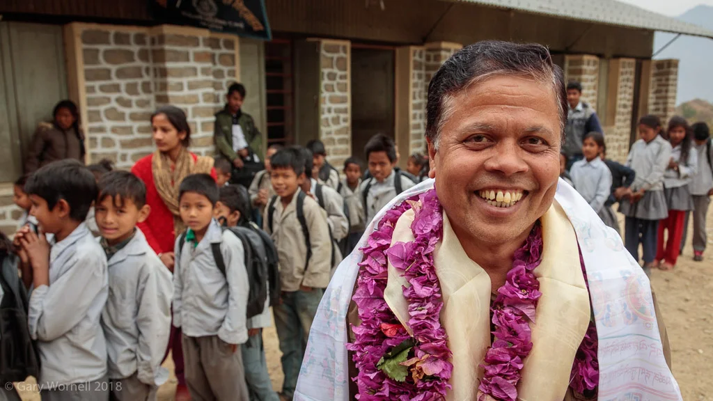 Our Auditor - happy to see the children in his home village receiving bags from MMN.