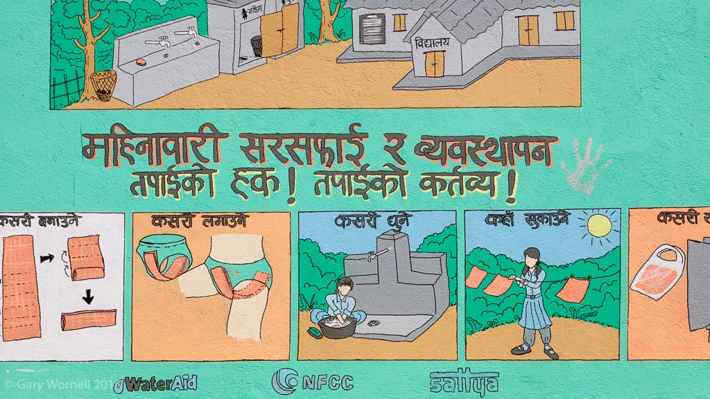 Water Aid supported info graphic for menstruating girls on the school wall.