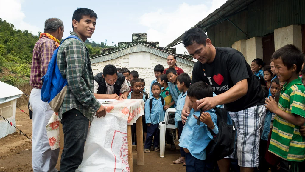Rajan (L) during one of Moving Mountain Nepal's first donations after the earthquake almost three years ago. (2015)