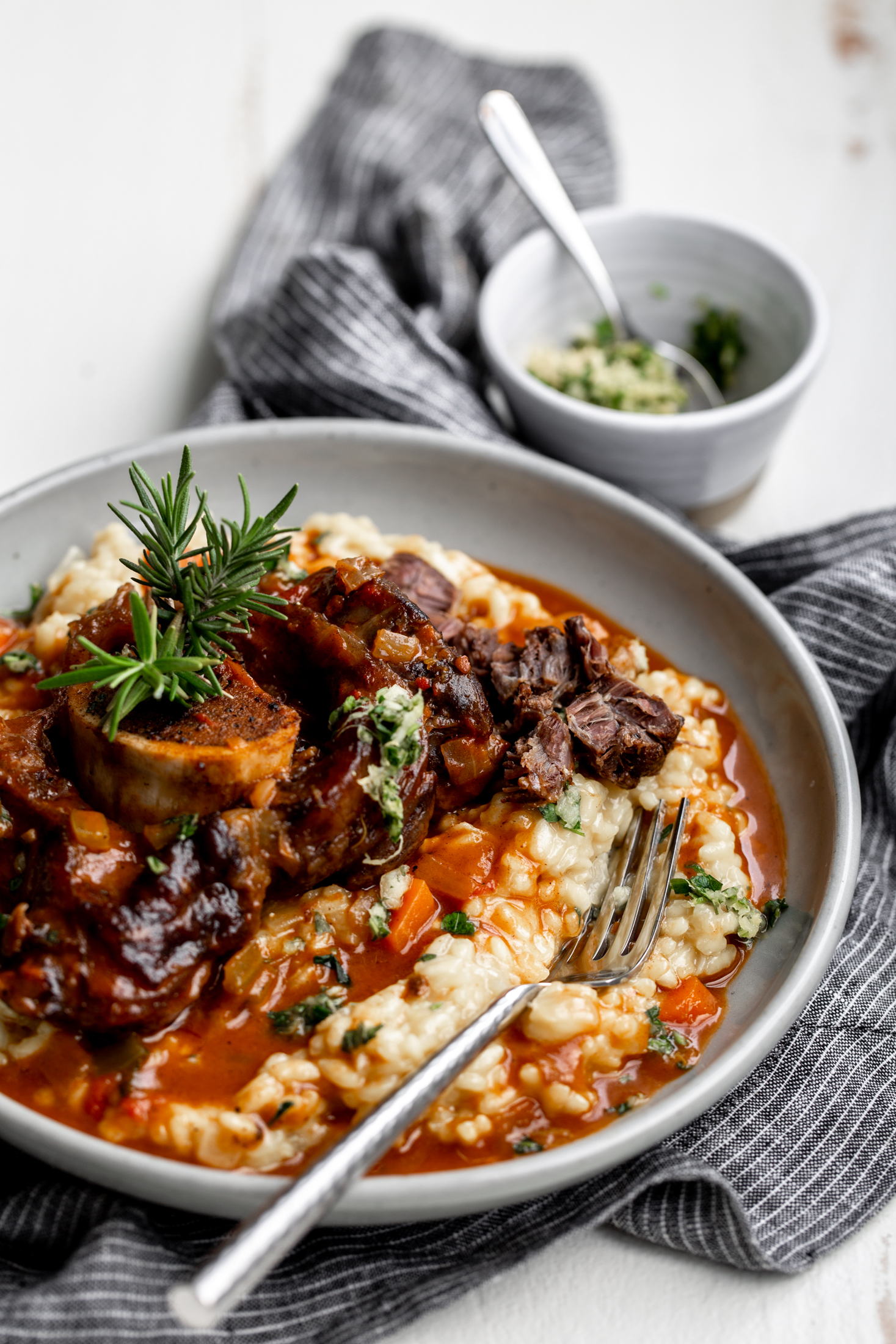 Veal Osso Buco over saffron risotto with fork