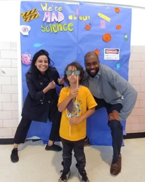 Dr. Sweta Batni and Dr. Christopher Williams pose with a student at Bancroft Science Night.