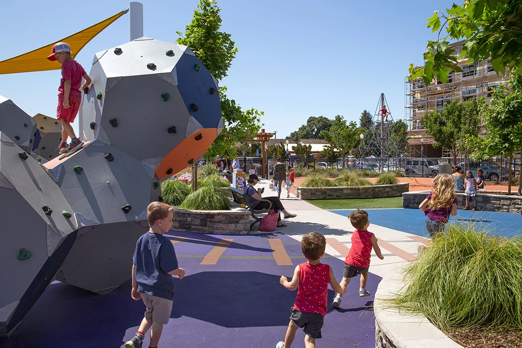 Morgan Hill Parks and Trails Renovation / Working with Morgan Hill to extend its downtown vision into a comprehensive, accessible park system, JLJA designed conceptual site plans for three distinct, yet complimentary parks and carefully integrated them into the urban fabric. Railroad Park is an active space with dynamic play equipment ranging from climbing structures and webbing to a giant wood xylophone. Little Third Street Creek Park is a passive recreation-based park with benches, tables, and pathways highlighting the creek and its natural features, including riparian habitat restoration. Both parks feature drought-tolerant landscapes and offer wi-fi connections and device charging stations. Nob Hill Trail Park is a multi-use trail and for walkers and runners that connects to downtown and adjacent trails. Located atop Nob Hill, it boasts stellar views, fitness equipment, and a custom slide to make the descent experience even more unique. To increase safety, trail design includes narrowing and making one-way the street that leads to the trail.