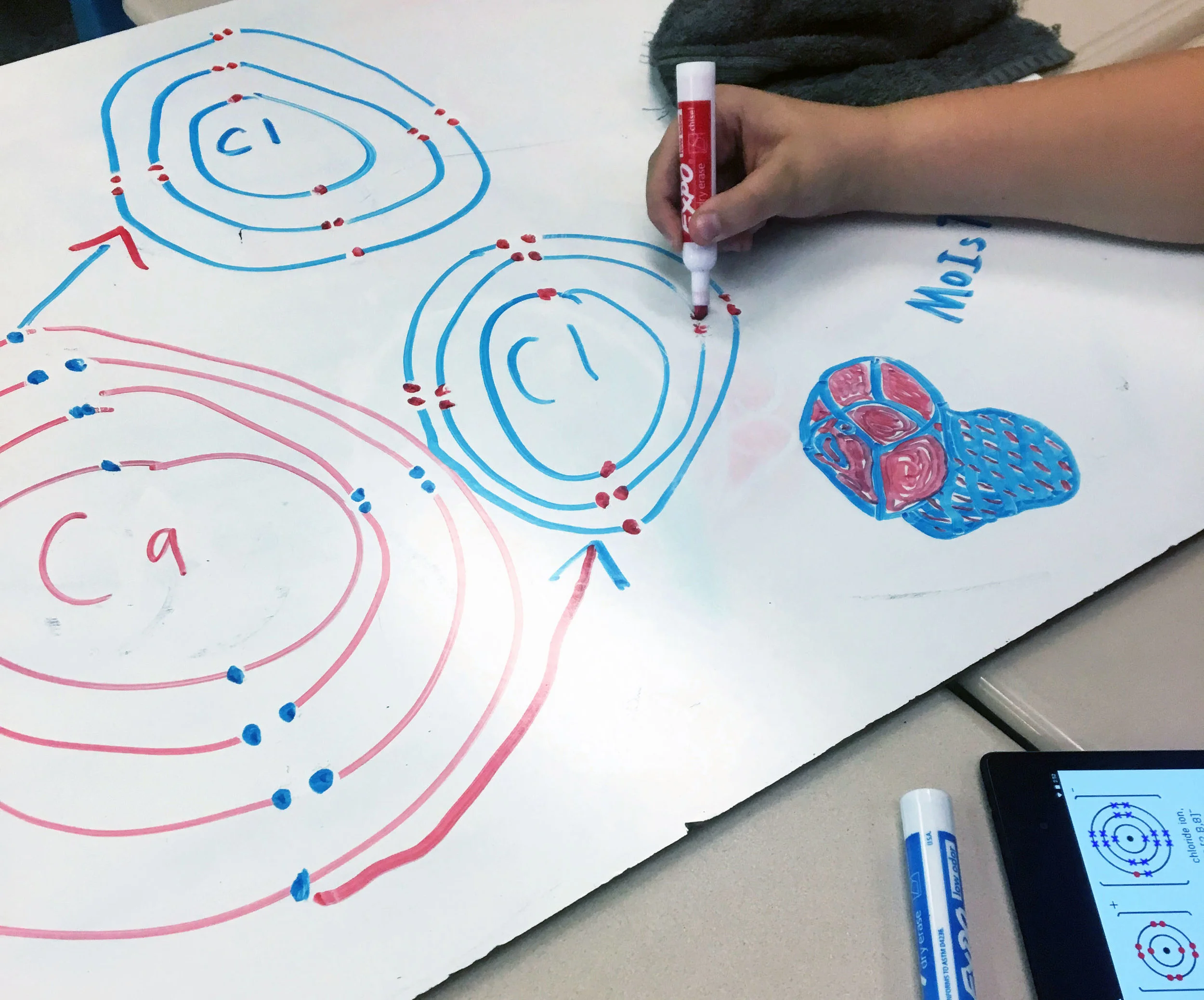 Students envision ideas for their sculptures using white boards.