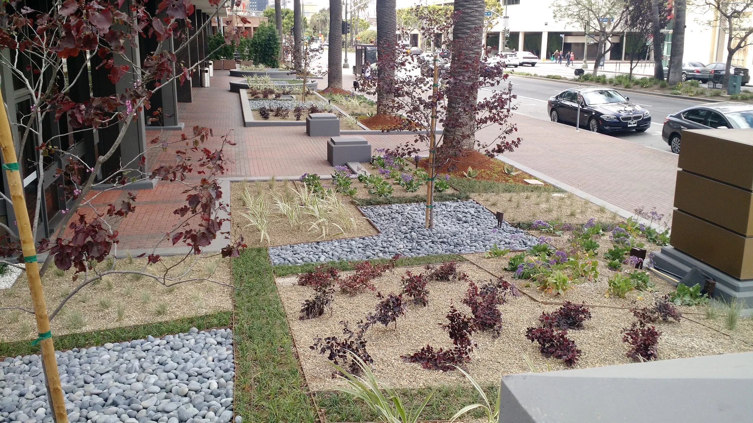 A fabric of landscape materials designed to integrate with the modern basket weave of the new parking structure. The landscape design is a complex system of layers and patterns representing the city and its complexity.