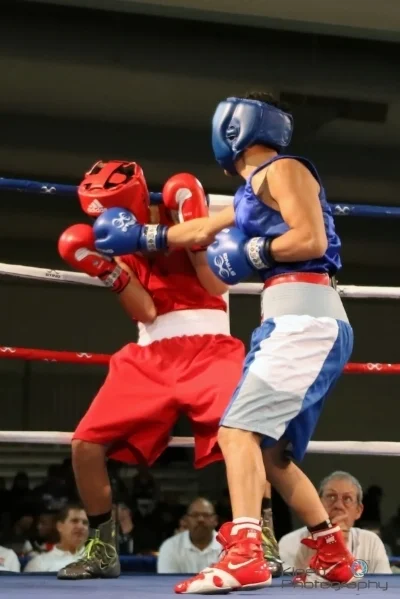 Portland Boxing Club's Gabriel "Tito" Morales (right/blue trunks) of Portland, ME and Jason Meza of National City, CA (left/red trunks). Photo courtesy of Kineo Photography.
