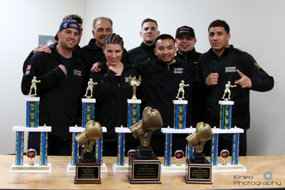 Portland Boxing Club teammates at the 2017 Northern New England Golden Gloves Championships in Essex Jct, VT. (Back row, left to right) Ivan Papkee (partially blocked), Head Coach Bobby Russo, Zach DiSilva, and Coach Jack Lumus. (Front row, left to right) Jason Quirk, Kate Zehr, Danny Pang and Josniel Castro. Photo courtesy of Kineo Photography.