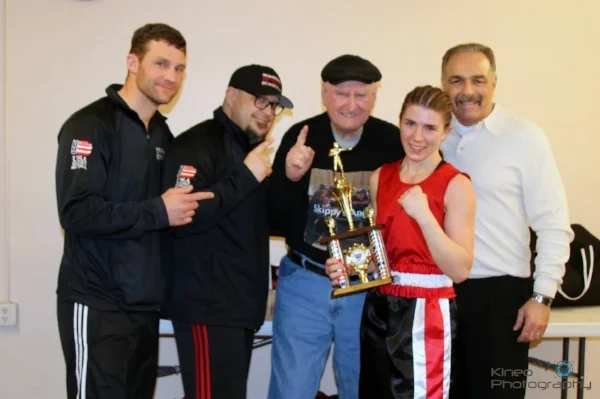 Kate Zehr along with her Portland Boxing Club Coaches, from left to right: Ivan Papkee who assisted Kate in the corner, Coach Jack Lumus, Coach Skip Neals, Kate Zehr and Head Coach Bobby Russo. Photo courtesy Kineo Photography.